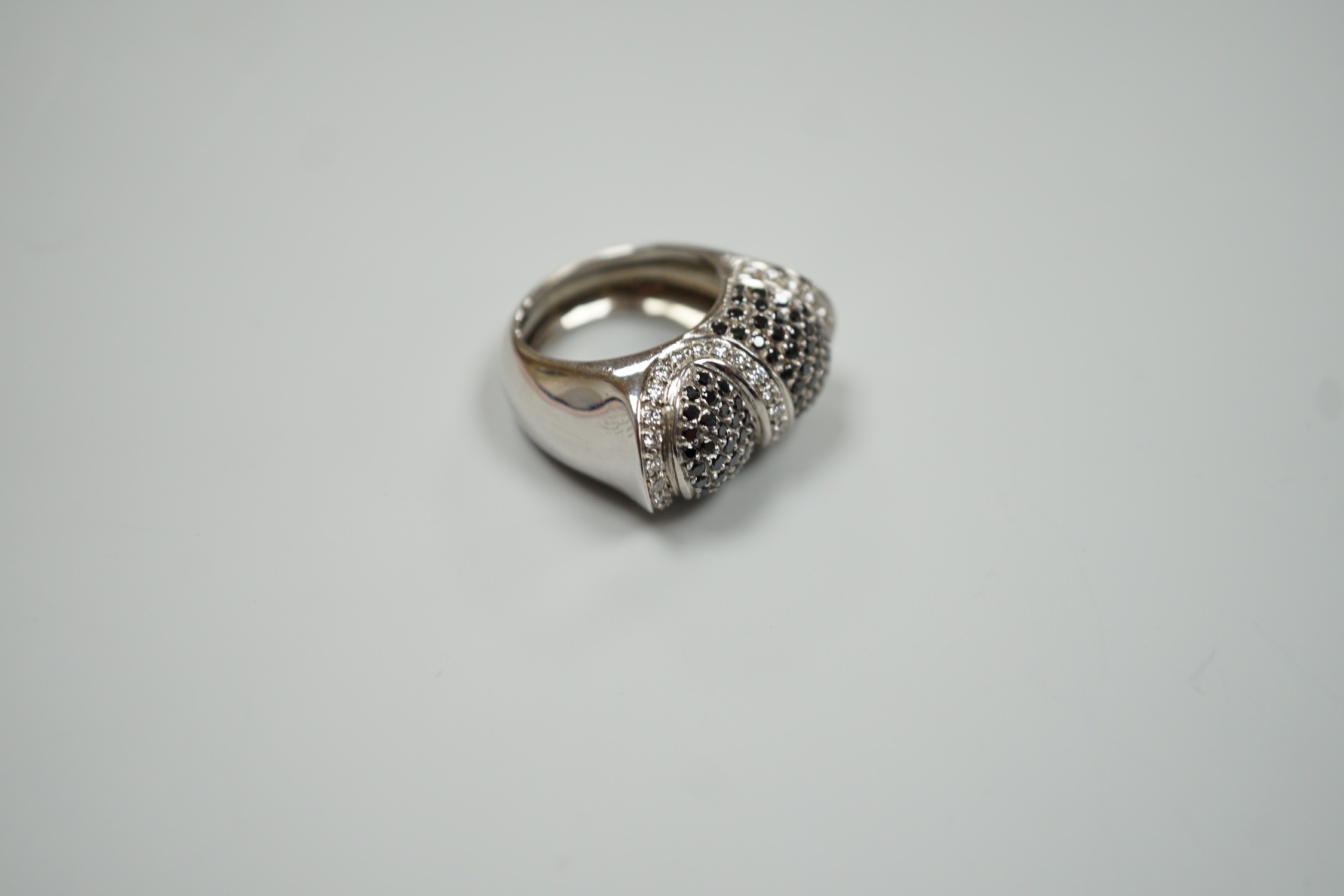 A modern 750 white metal and pave set two colour diamond dress ring, size K/L, gross weight 15.4 grams.